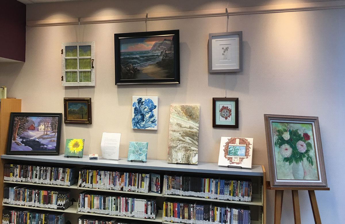 Display of several paintings including abstracts, still lifes and landscapes