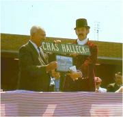 Charlie Halleck is presented with a street sign bearing his name. - Full image.