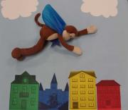 Curious George flying over a city