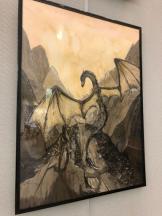 Inkwash drawing of a majestic dragon spreading its wings on a rocky point.